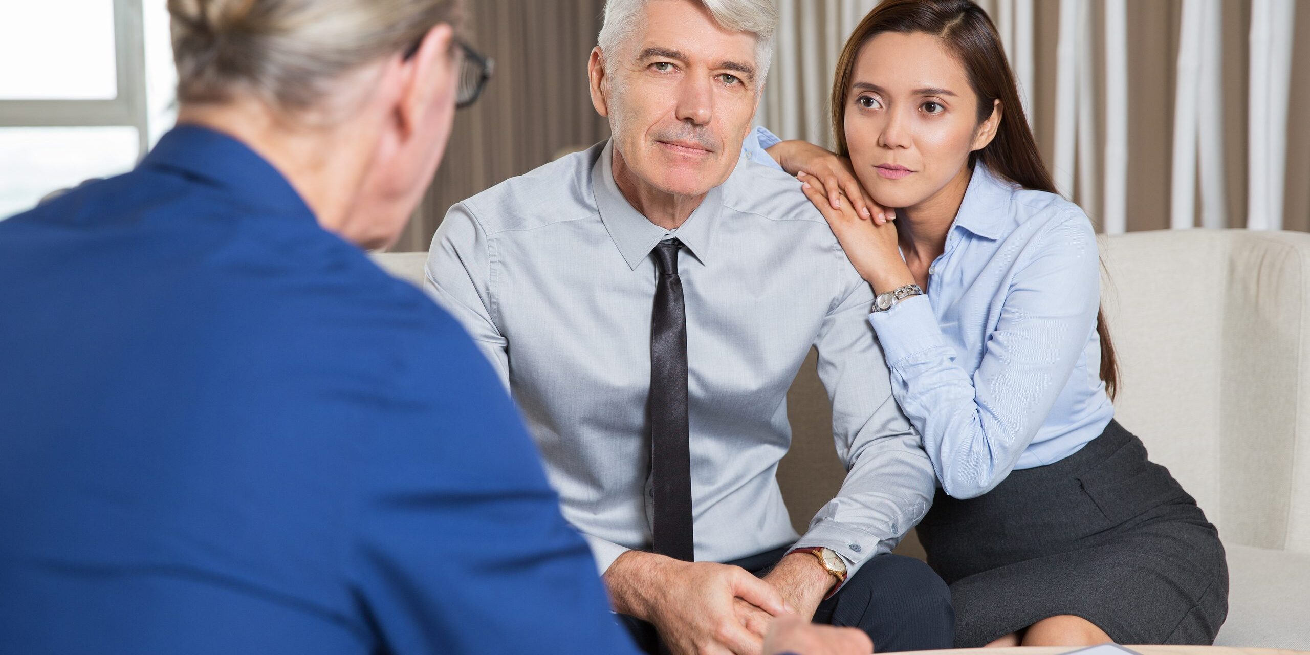 Senior Businessmen and Young Woman Negotiating