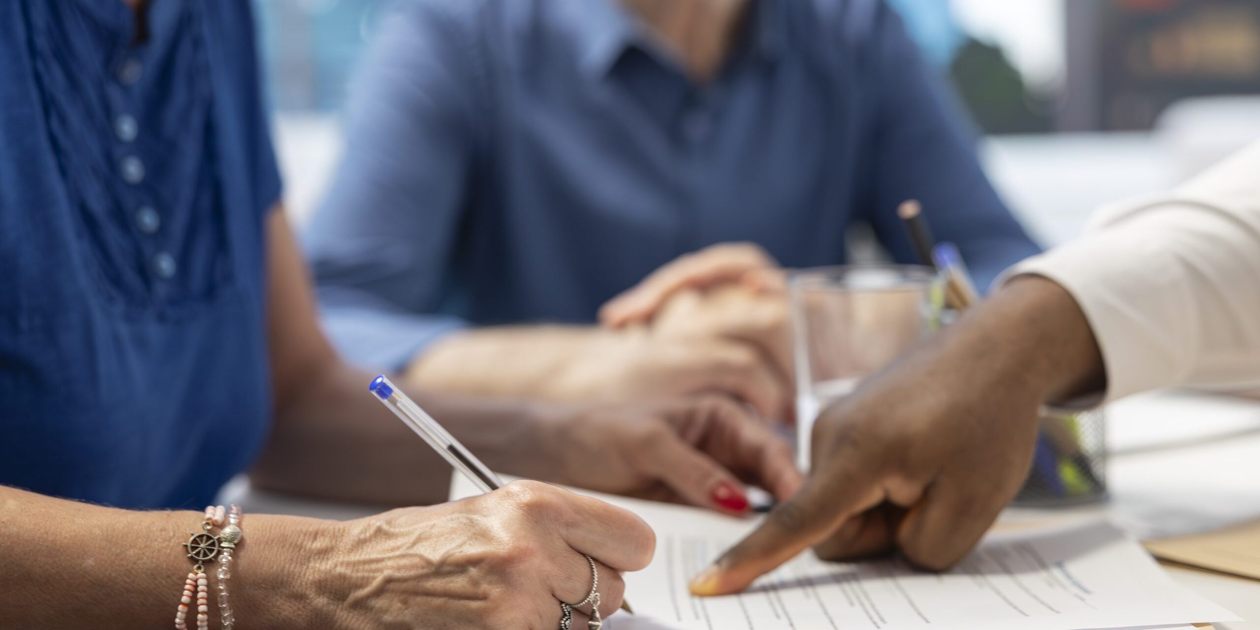 Middle aged woman signing retirement plan contract to secure the future income